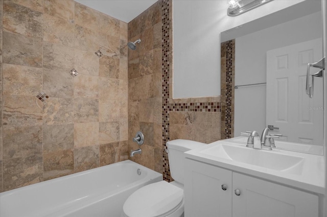 full bathroom with vanity, tiled shower / bath combo, and toilet