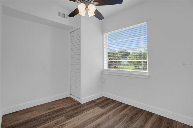 spare room featuring dark hardwood / wood-style flooring and ceiling fan