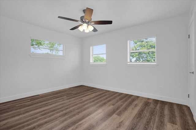 empty room with dark wood-type flooring and ceiling fan