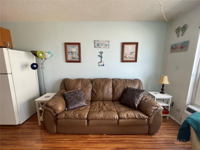 living room with a textured ceiling and wood-type flooring