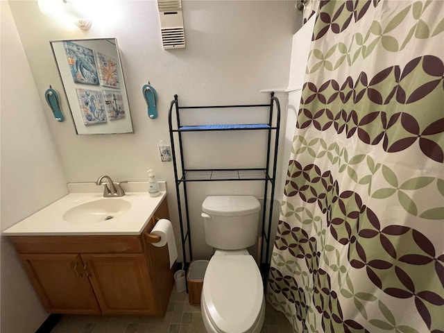 bathroom featuring vanity, toilet, a shower with curtain, and tile patterned flooring