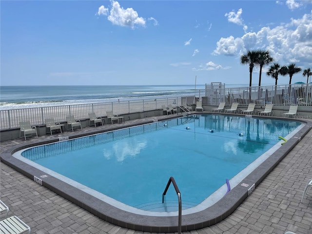 view of swimming pool featuring a water view