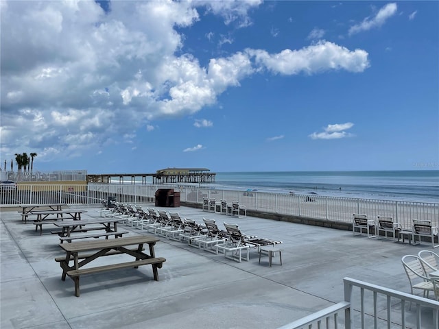 view of patio / terrace featuring a beach view and a water view