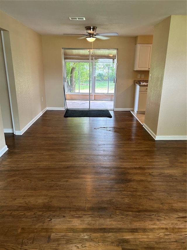 spare room featuring dark hardwood / wood-style floors and ceiling fan