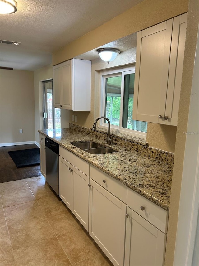 kitchen with white cabinetry, plenty of natural light, dishwasher, and sink