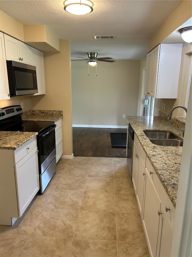 kitchen with white cabinetry, appliances with stainless steel finishes, and sink