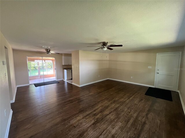 unfurnished living room with a textured ceiling, dark hardwood / wood-style floors, and ceiling fan