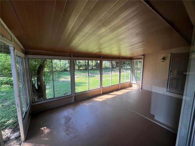 unfurnished sunroom featuring wood ceiling and lofted ceiling