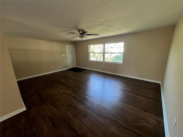 empty room with ceiling fan and dark hardwood / wood-style floors