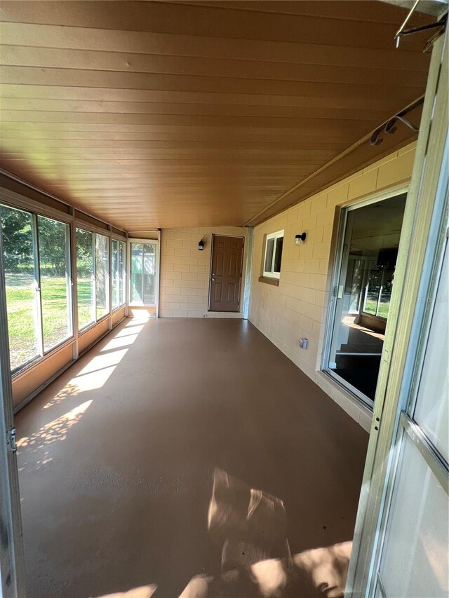 unfurnished sunroom with vaulted ceiling