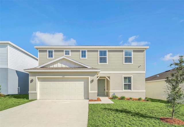 view of front of home featuring a garage and a front lawn