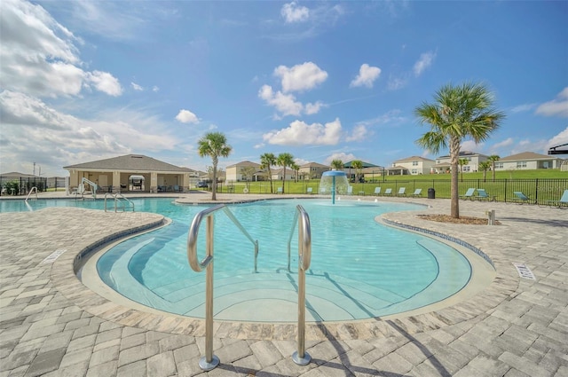 view of swimming pool featuring pool water feature and a patio area