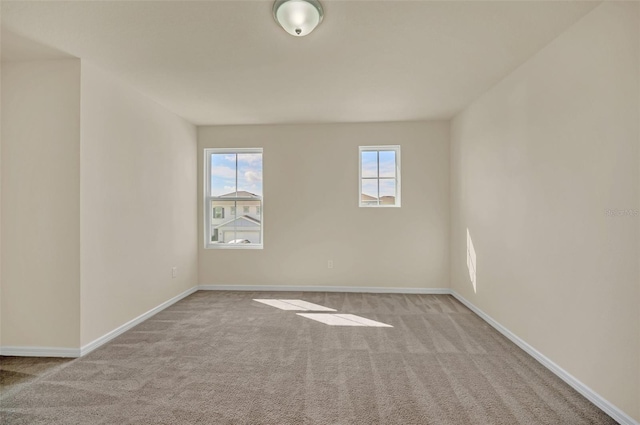 unfurnished room with light carpet