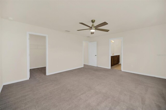 spare room featuring carpet flooring and ceiling fan