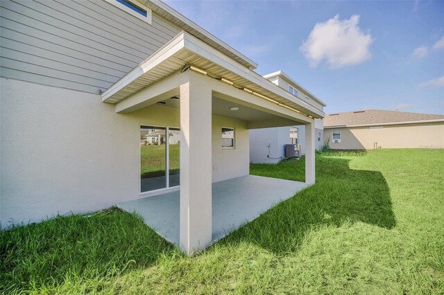 view of yard with cooling unit and a patio area