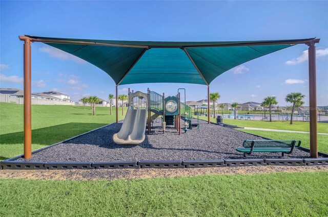 view of play area with a water view and a yard