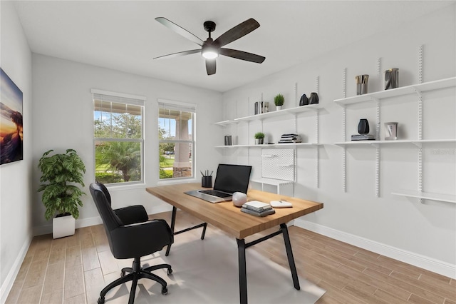 home office with ceiling fan and light hardwood / wood-style flooring