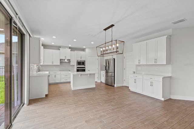 kitchen with white cabinetry, light hardwood / wood-style flooring, stainless steel appliances, and plenty of natural light