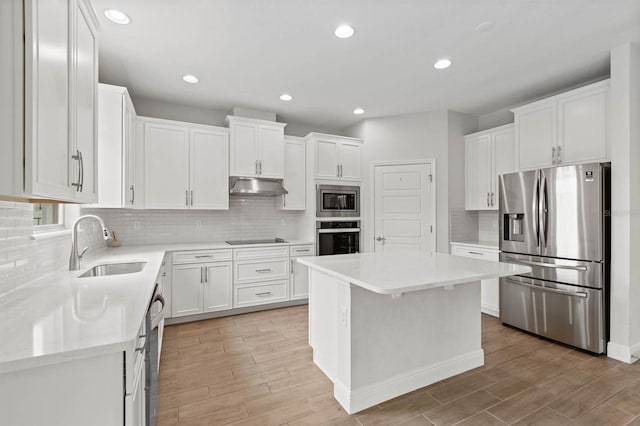 kitchen with light hardwood / wood-style floors, white cabinetry, a center island, and stainless steel appliances