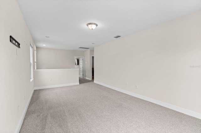 spare room featuring light colored carpet