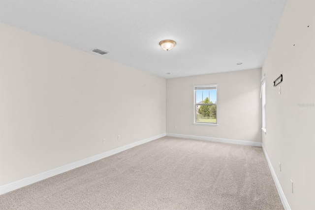 unfurnished room featuring light carpet