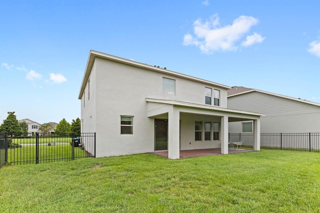 rear view of house with a yard and a patio area