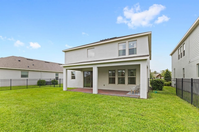 back of property featuring a patio area and a yard