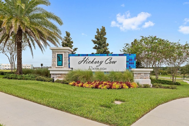 community / neighborhood sign with a lawn