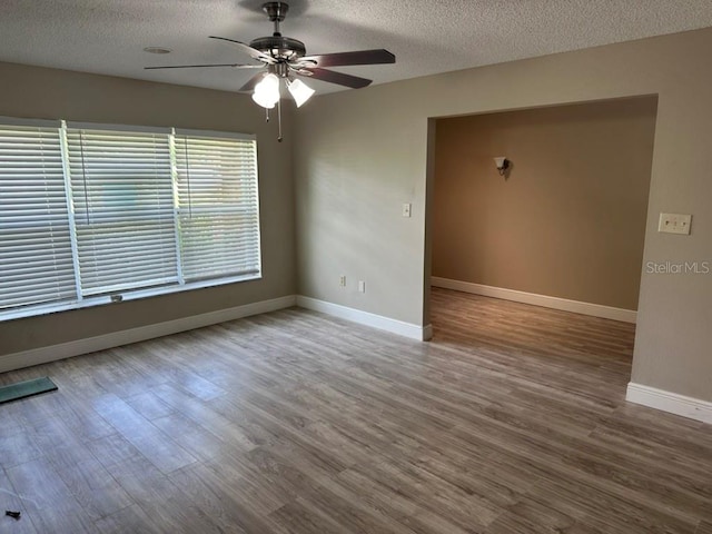 unfurnished room with hardwood / wood-style floors, a textured ceiling, and ceiling fan