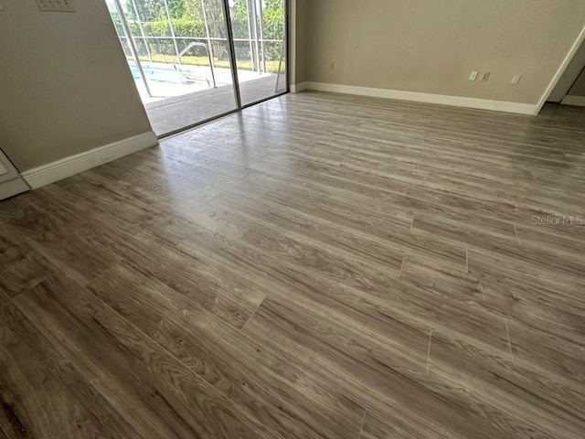 unfurnished room featuring hardwood / wood-style flooring