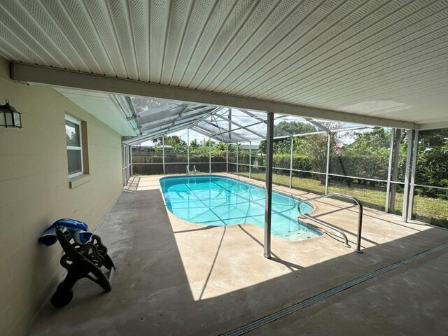 view of pool featuring a patio and glass enclosure