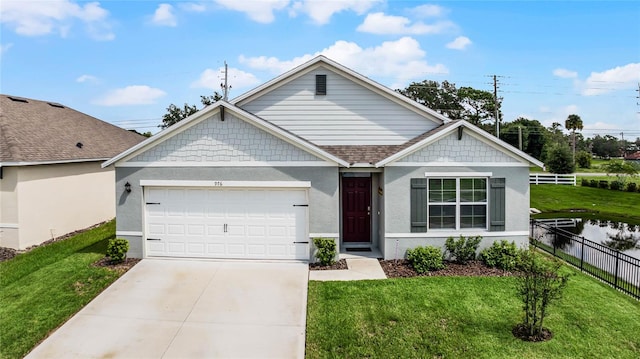 view of front of property with a garage and a front lawn