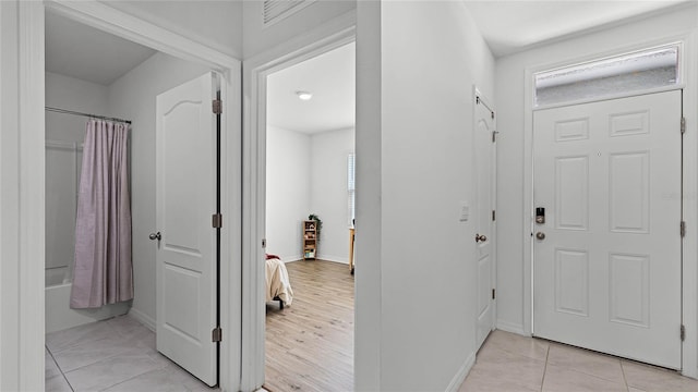 hallway with light tile patterned floors