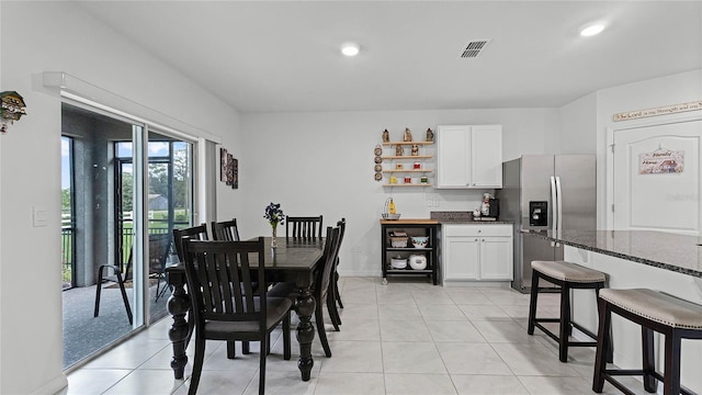 dining area featuring light tile patterned floors