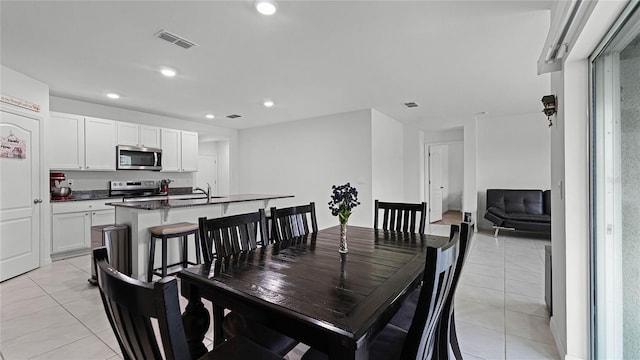 tiled dining room with sink