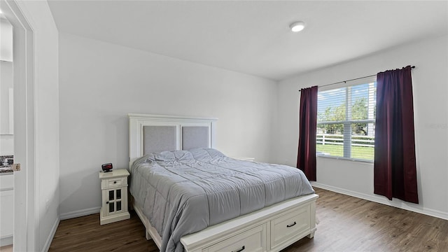 bedroom with dark hardwood / wood-style flooring