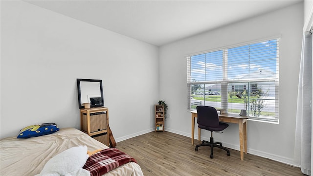 bedroom with wood-type flooring