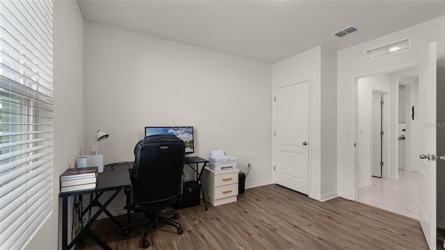 home office with wood-type flooring