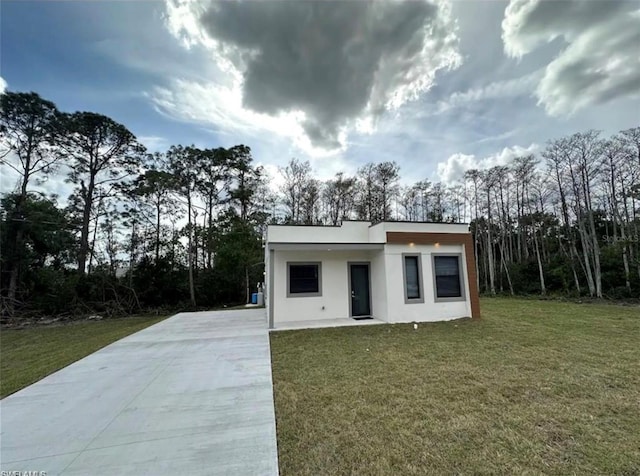 contemporary house with a front yard and a carport