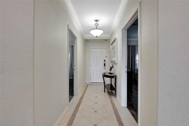 hall with light tile patterned floors and ornamental molding