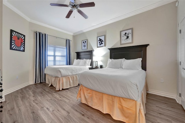 bedroom with ornamental molding, ceiling fan, and hardwood / wood-style flooring