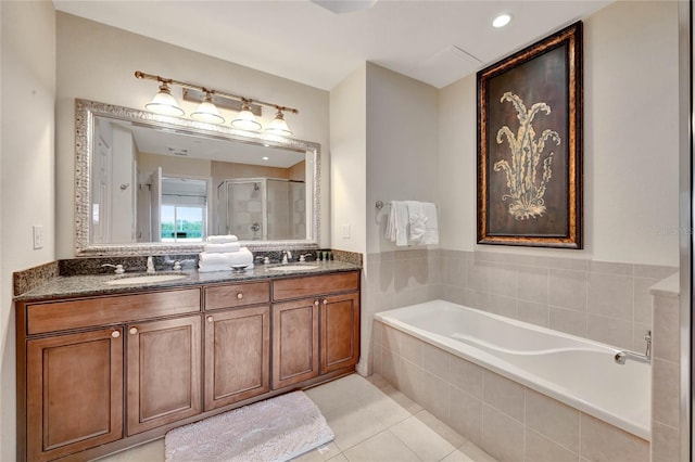 bathroom with tile patterned flooring, vanity, and plus walk in shower