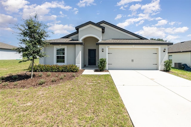 ranch-style home with a garage, a front lawn, and central AC