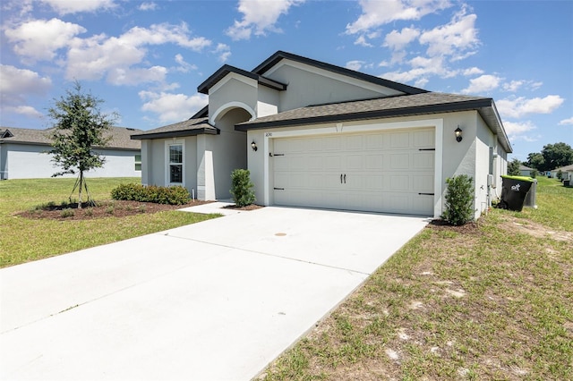 view of front facade with a front yard and a garage