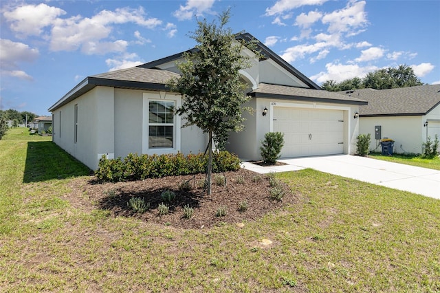 single story home with a garage and a front lawn