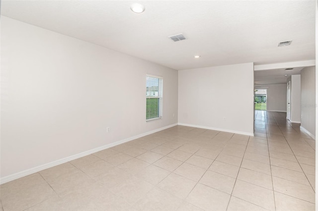 unfurnished room featuring plenty of natural light and light tile patterned floors