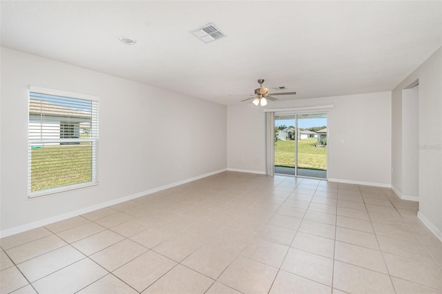 tiled empty room with ceiling fan