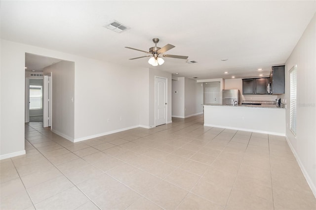 unfurnished living room with ceiling fan and light tile patterned flooring