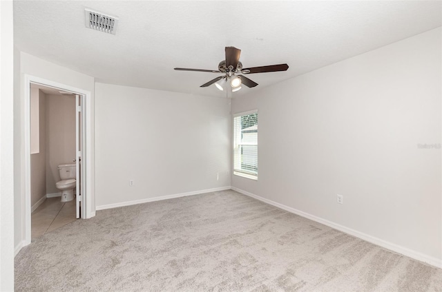 carpeted empty room featuring ceiling fan