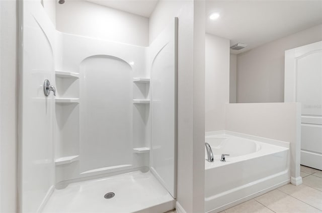 bathroom featuring tile patterned flooring and independent shower and bath